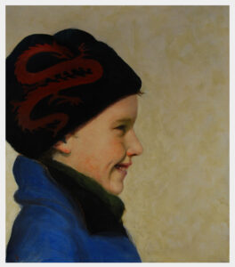 Realistic portrait in profile of a young boy wearing a hat with a dragon design outside in winter.